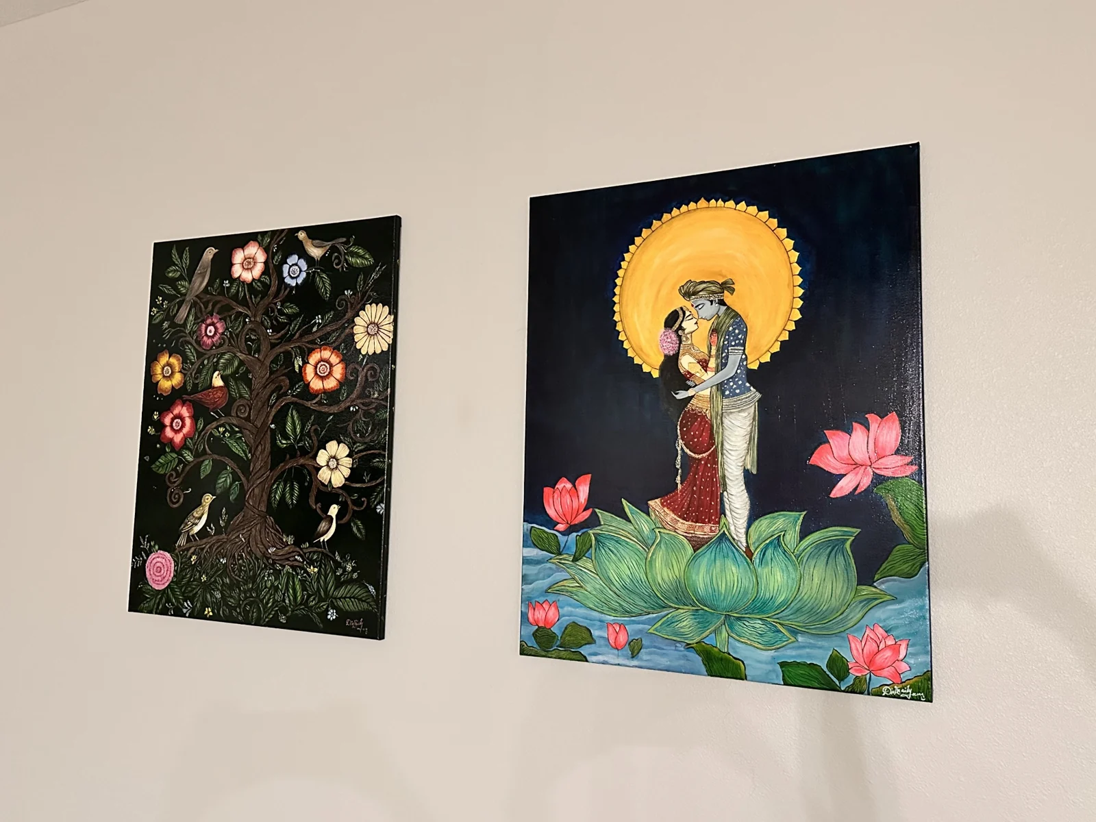 Original paintings displayed on a wall